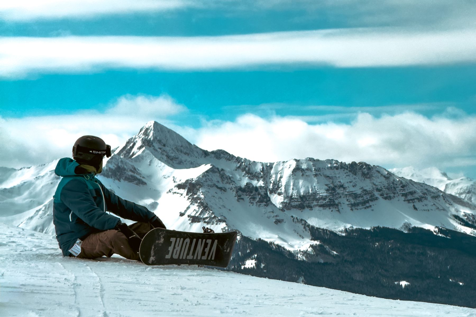 Snowboarder Rests at See Forever Vista